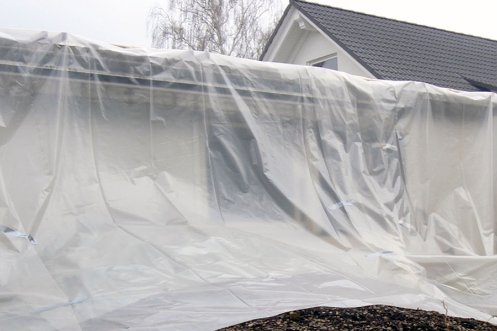 Mauer mit Plastikschutz abgedeckt – Verdacht auf Asbest.
